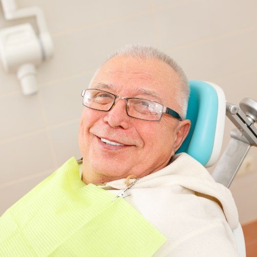 Senior man smiling in dental chair