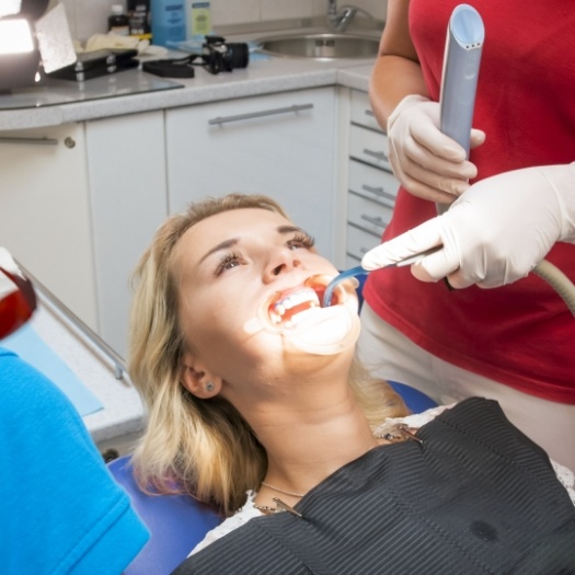 Dentist shining a light into a patients mouth
