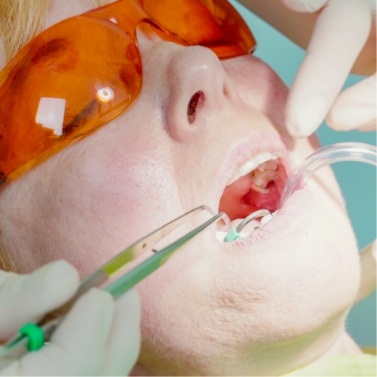 Dental patient wearing dental sunglasses while receiving treatment