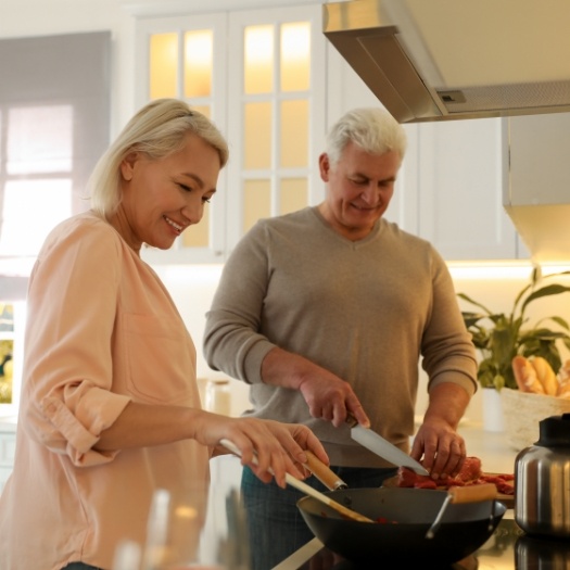 Senior man and woman cooking together