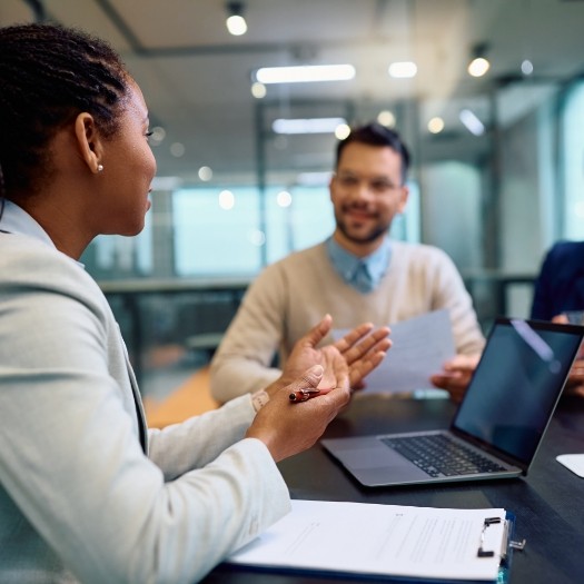 Two businesspeople talking at desk