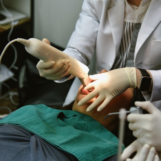 Dentist capturing digital impressions of a patients teeth