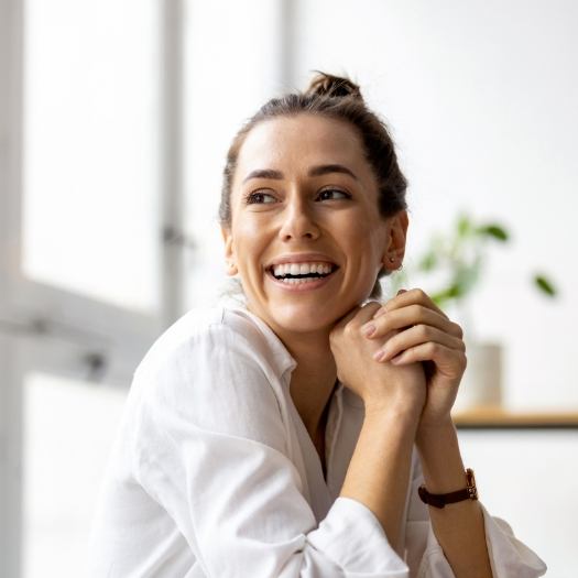 Smiling woman with her hair in a bun