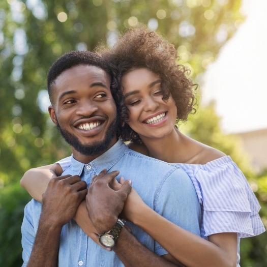 Man and woman hugging outdoors