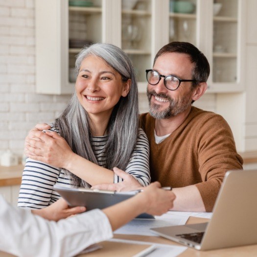 Man and woman hugging while sitting at desk