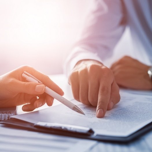 Two people looking at paperwork on clipboard