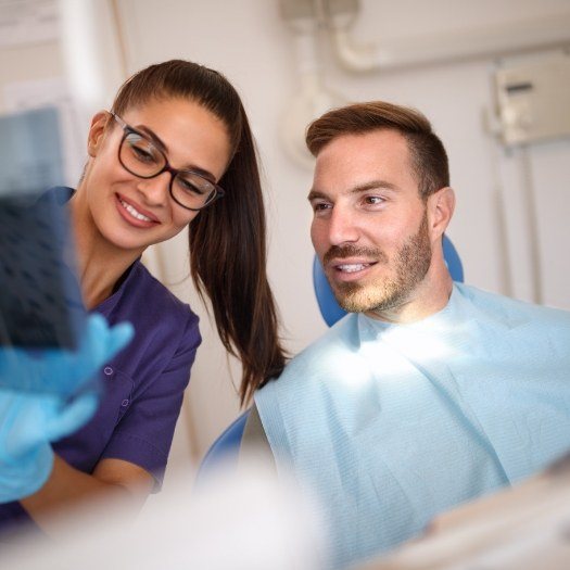 San Antonio dental team member showing a screen to a patient