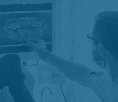 Dentist showing a patient x rays of their teeth