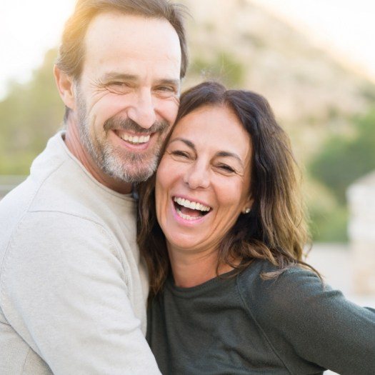 Man and woman laughing together outdoors