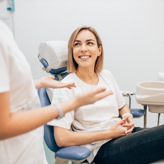 Woman listening to her dentist explain dental post op instructions in San Antonio