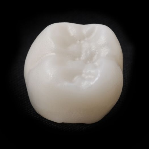 Dental crown on black background