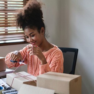 Woman using scissors to cut a string