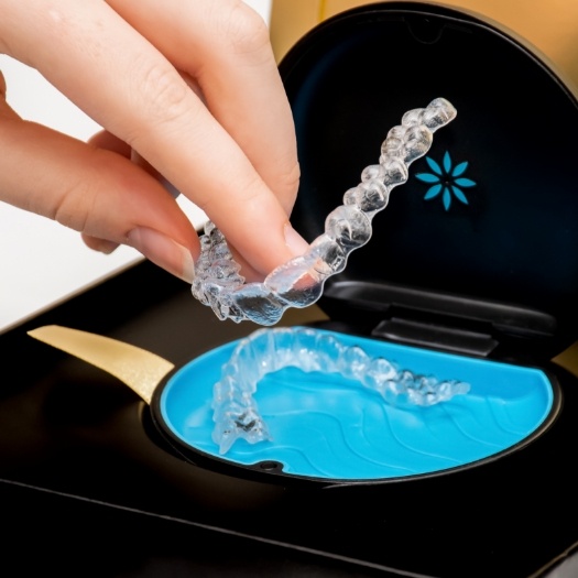 Person placing Invisalign aligners into their case