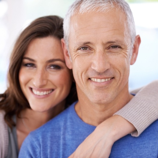 Older man and woman smiling together