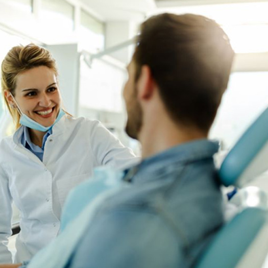 Dentist and patient having a friendly conversation