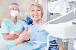 Happy patient making thumbs-up gesture
