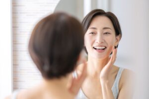 Woman looking at herself in mirror