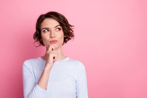 Woman wearing thoughtful, curious expression